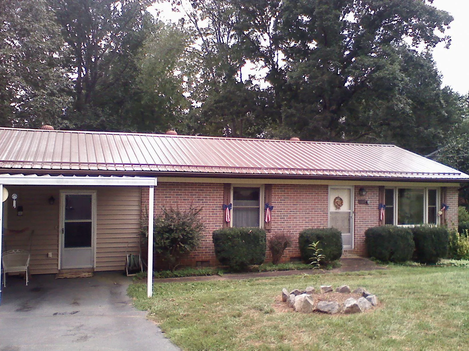 Bronze metal roof and carport on a brick ranch home — Roof Repair work by our crew in Camp Pendleton