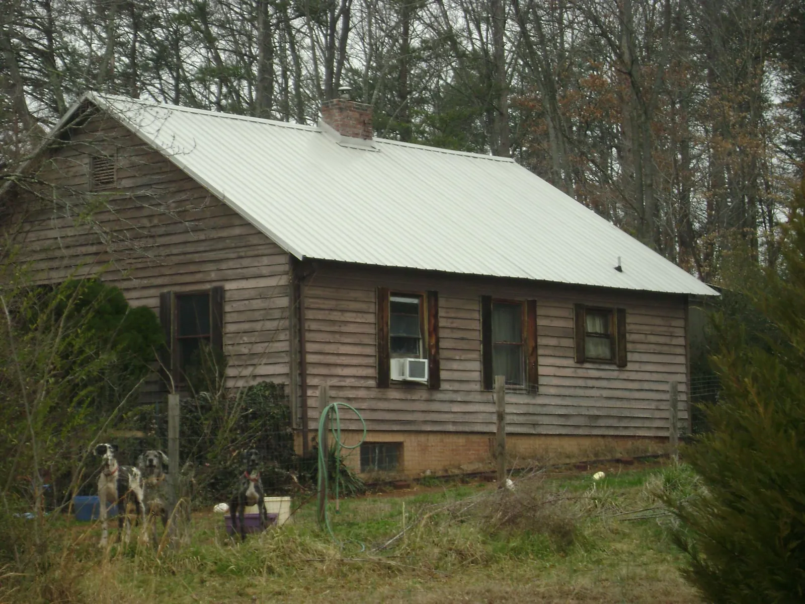 White metal roof on an old wood sided farmhouse, from a Metal Roof Installation job in Camp Pendleton